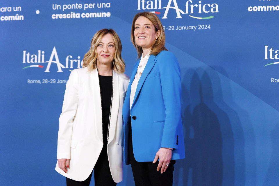 Italian Premier Giorgia Meloni, left, welcomes President of the European Parliament Roberta Metsola, ahead of an Italy - Africa summit, in Rome, Monday, Jan. 29, 2024. Meloni opened a summit of African leaders on Monday aimed at illustrating Italy's big development plan for the continent that her government hopes will stem migration flows and forge a new relationship between Europe and Africa. (Roberto Monaldo/LaPresse via AP)