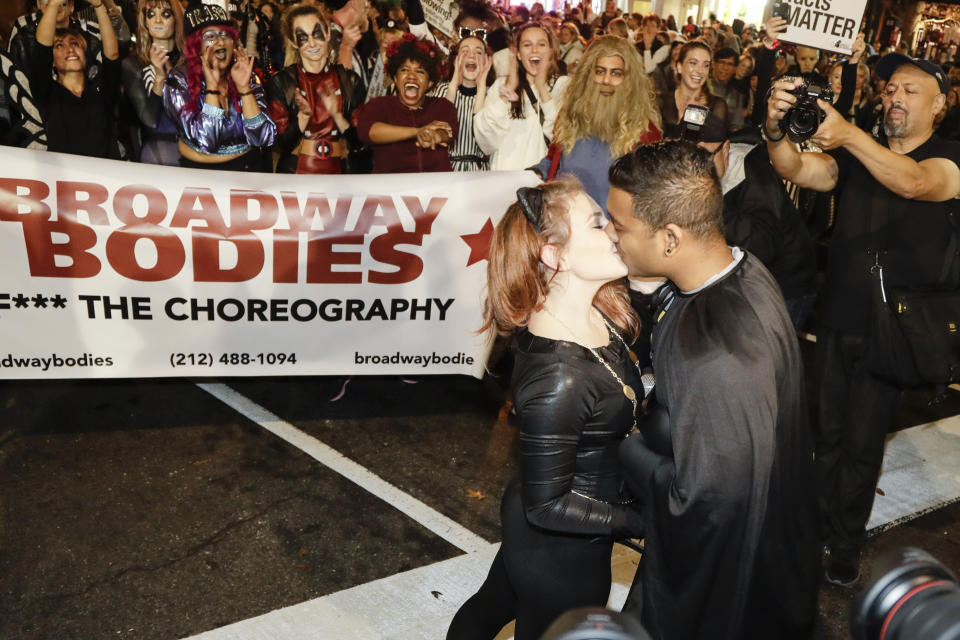 A couple kisses after getting engaged during the Greenwich Village Halloween Parade, Thursday, Oct. 31, 2019, in New York. (AP Photo/Frank Franklin II)