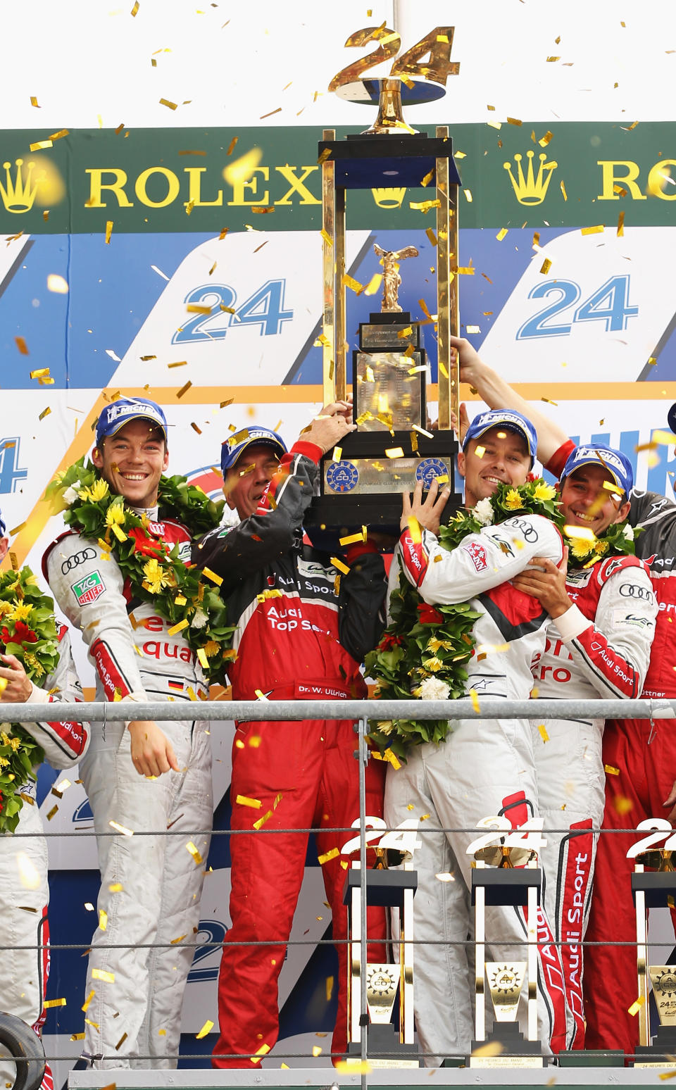 The winning car Audi Sport Team Joest R18 E-Tron Quattro (front right No.1) of Andre Lotterer, Marcel Fassler and Benoit Treluyer cross the finishing line at the end of the Le Mans 24 Hour race at the Circuit de la Sarthe on June 16, 2012 in Le Mans, France. (Photo by Bryn Lennon/Getty Images)