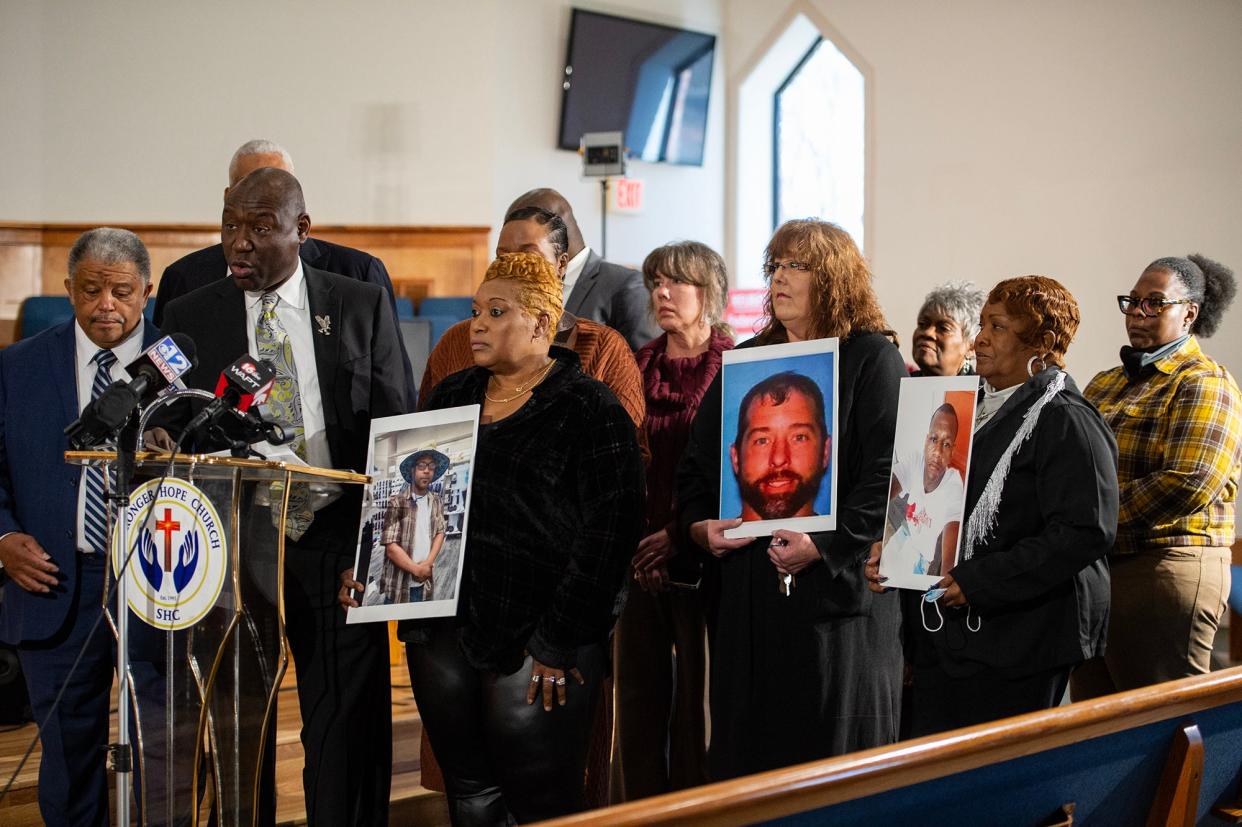 Attorney Ben Crump stands with the families of Dexter Wade, Marrio Moore, and Jonathan Hankins at a press conference about their cases in Jackson, Miss., on Wednesday, Dec. 20, 2023. All three men were buried in the Hinds County Pauper’s Field in unmarked graves without contacting their families.