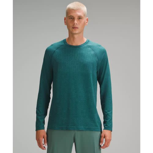 model wearing teal long sleeve lululemon top with green shorts