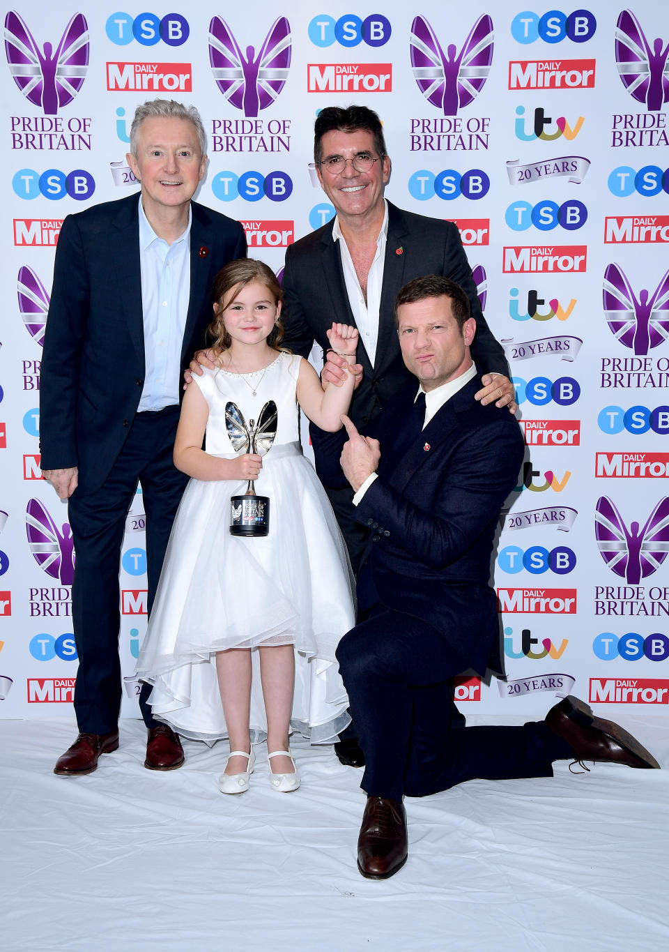 Jaydee-Lee Dummett with her Child of Courage award poses with Louis Walsh, Dermot O'Leary and Simon Cowell during the Pride of Britain Awards held at the The Grosvenor House Hotel, London.