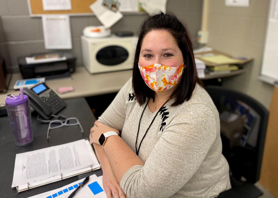 Image: Stefanie Fernandez works for a company that has encouraged its employees to substitute teach in local schools. Armed with a binder of 