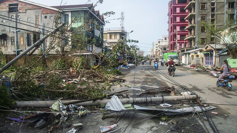 Locals ride motorbike while lamp-posts and trees are fallen after Cyclone Mocha in Sittwe township, Rakhine State, Myanmar, Monday, May 15, 2023. Rescuers on Monday evacuated about 1,000 people trapped by seawater 12 feet deep along western Myanmar’s coast after the powerful cyclone injured hundreds and cut off communications.