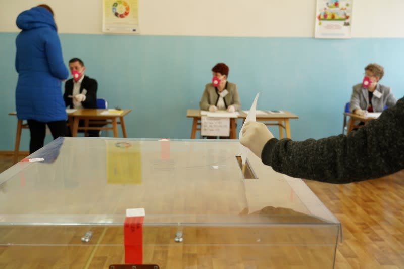 Local election commission members wearing protective masks during byelections in Bemowo Pilskie