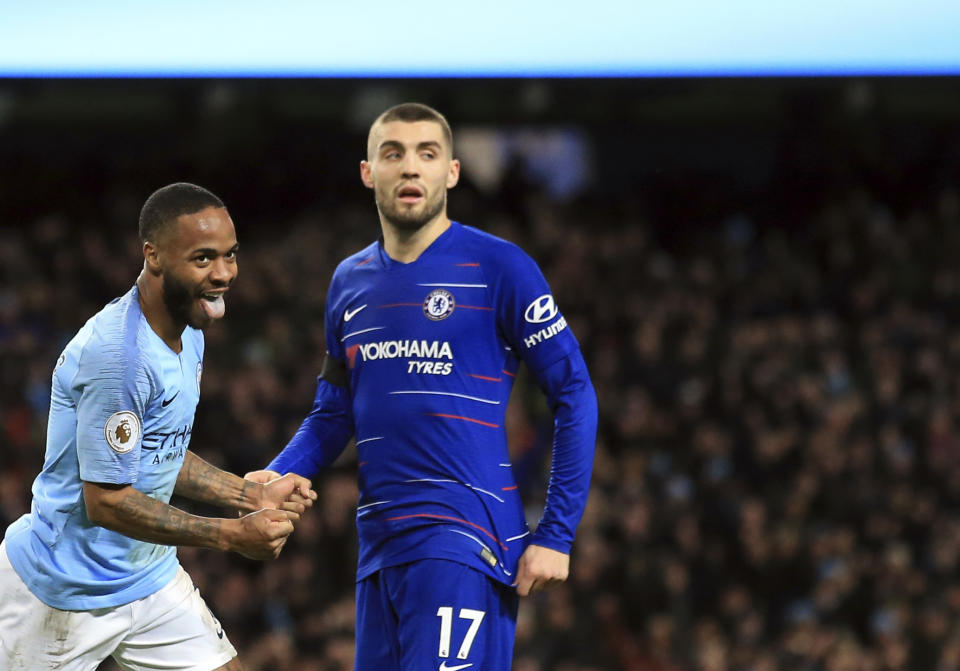 Manchester City's Raheem Sterling, left, celebrates after scoring his side's sixth goal during the English Premier League soccer match between Manchester City and Chelsea at Etihad stadium in Manchester, England, Sunday, Feb. 10, 2019. (AP Photo/Jon Super)