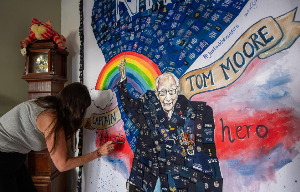 Artist Sam Bailey puts the finishing touches to a mural acknowledging the work being done by the NHS, emergency services and the fundraising exploits of Captain Tom Moore, at her home in Northampton as the UK continues in lockdown to help curb the spread of the coronavirus.