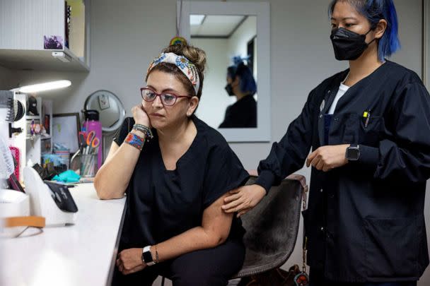 PHOTO: Catalina Leona and Terri Chen, staff at Houston Women's Reproductive Services watch a livestream of President Joe Biden delivering remarks before signing an executive order in Houston, Texas, July 8, 2022. (Evelyn Hockstein/Reuters)