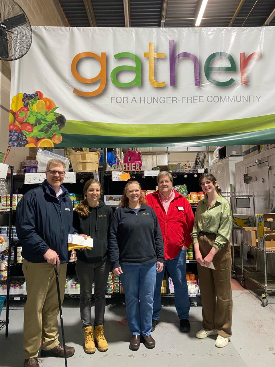 COAST Rad Nichols presents Gather staff with the proceeds from the “Day It Forward” campaign