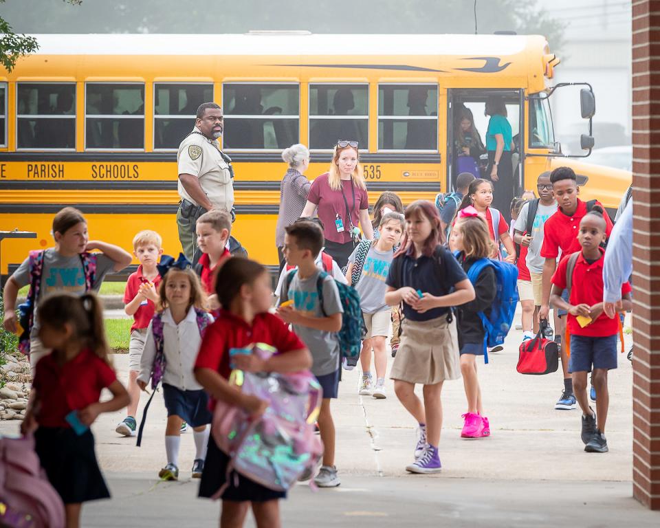 Students arrive at J Wallace James Elementary for the first day of school in Lafayette, Thursday.