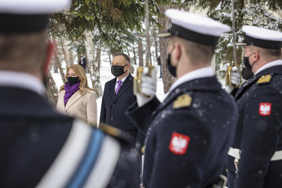 Poland's military stand at attention as President Andrzej Duda welcomes Slovakia's President Zuzana Caputova for a two-day summit with the presidents of Hungary and The Czech Republic marking 30 years of the Visegrad Group, an informal body of political and economic cooperation in the region, at the presidential residence in the Hel Peninsula, Poland, on Tuesday, Feb. 9, 2021.(Jakub Szymczuk / KPRP via AP )