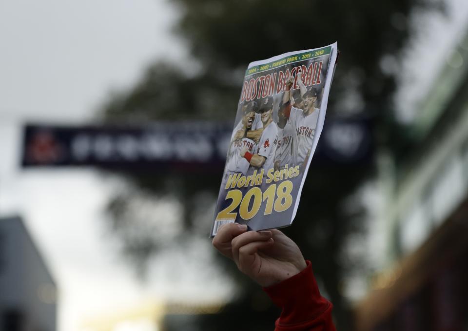 A vendor sells a program outside Fenway Park for Game 2 of the World Series baseball game between the Boston Red Sox and the Los Angeles Dodgers Wednesday, Oct. 24, 2018, in Boston. (AP Photo/Matt Slocum)