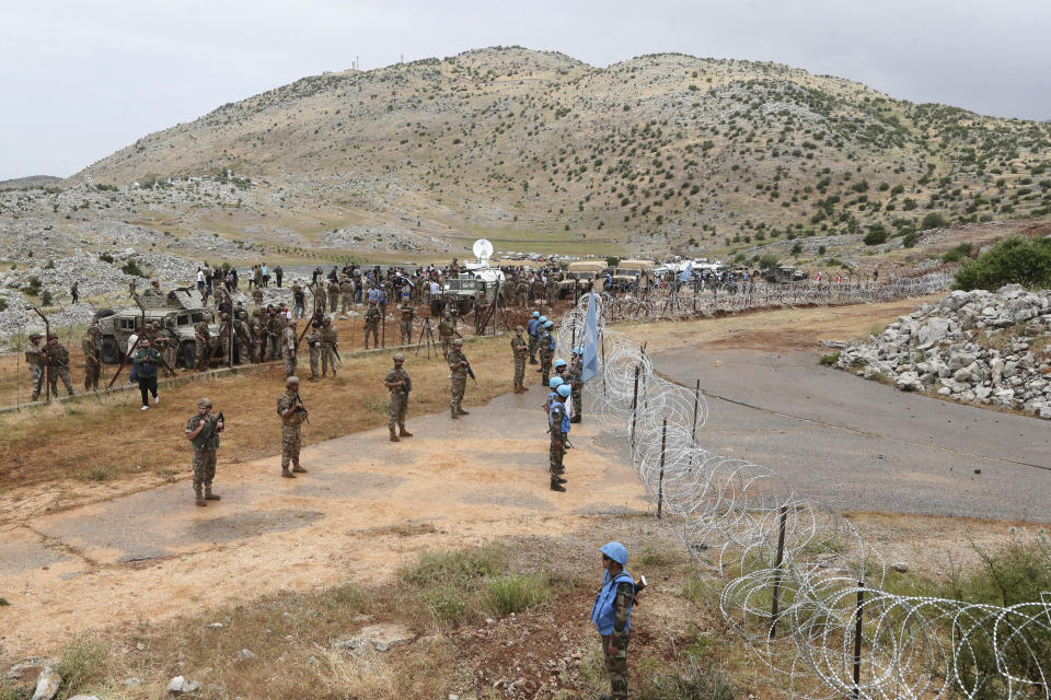 Lebanese troops and U.N. peacekeepers deploy along a fence at Lebanon's southern border with Israel in the disputed Kfar Chouba hills, Friday, June 9, 2023. Israeli soldiers fired tear gas to disperse scores of protesters who pelted the troops with stones along the border with Lebanon Friday, leaving some Lebanese demonstrators and troops suffering breathing problems. (AP Photo/Mohammad Zaatari)