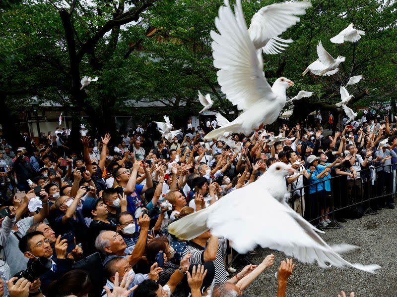 FILE PHOTO: People pay tribute to the war dead on the 78th anniversary of Japan's surrender in World War Two, in Tokyo