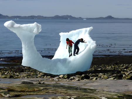 Children play amid icebergs on the beach in Nuuk, Greenland, June 5, 2016. REUTERS/Alister Doyle