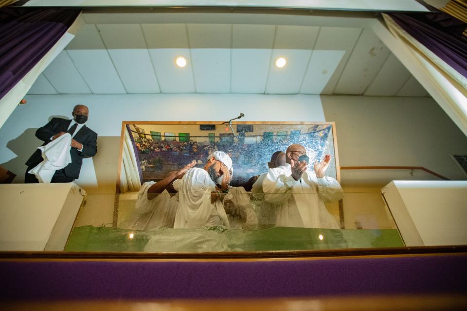 Rev. R.B. Holmes at Bethel Missionary Baptist Church baptizes nine Florida A&M University football players during service Sunday, Aug. 21, 2022.