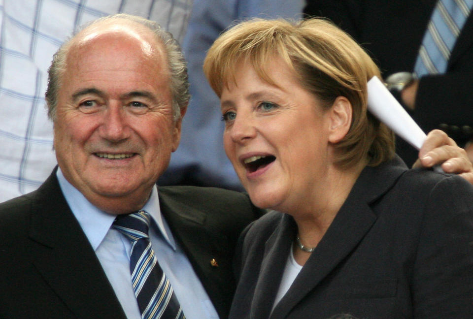 Stuttgart, GERMANY: FIFA president Sepp Blatter (L) and German Chancellor Angela Merkel (R) are seen at the start of the third-place playoff 2006 World Cup football match between Germany and Portugal at Stuttgart's Gottlieb-Daimler Stadium, 08 July 2006. AFP PHOTO / OLIVER LANG (Photo credit should read OLIVER LANG/AFP via Getty Images)