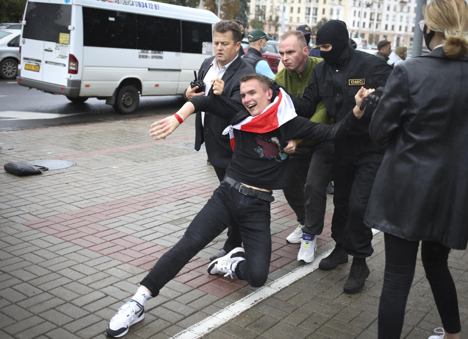 Police detain a student during a protest in Minsk, Belarus, Tuesday, Sept. 1, 2020. Several hundred students on Tuesday gathered in Minsk and marched through the city center, demanding the resignation of the country's authoritarian leader after an election the opposition denounced as rigged. Many have been detained as police moved to break up the crowds. (Tut.By via AP)