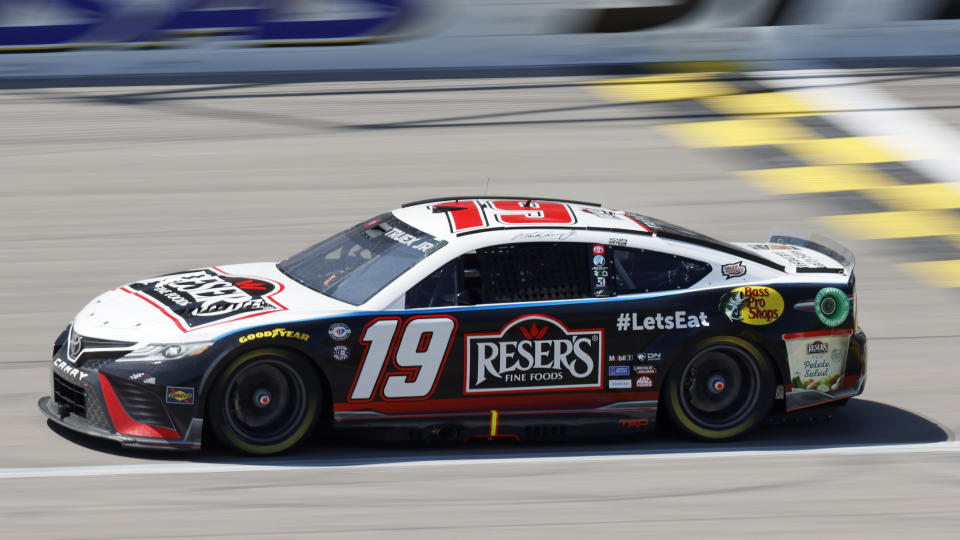 Martin Truex Jr. (19) heads down the front straightway after taking the lead during the first stage of a NASCAR Cup Series auto race at Kansas Speedway in Kansas City, Kan., Sunday, May 7, 2023. (AP Photo/Colin E. Braley)