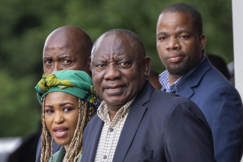 South African President Cyril Ramaphosa, center, leaves an African National Congress (ANC) national executive committee meeting in Johannesburg, South Africa, Monday Dec. 5, 2022. Ramaphosa might lose his job, and his reputation as a corruption fighter, as he faces possible impeachment over claims that he tried to cover up the theft of millions of dollars stashed inside a couch on his farm. (AP Photo/Jerome Delay)