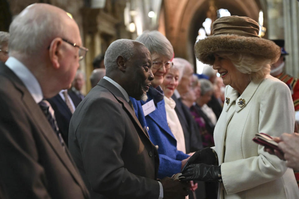 Britain's Queen Camilla hands out the Maundy Money during the Royal Maundy Service, in Worcester, England, Thursday, March 28, 2024. Maundy Thursday is the Christian holy day falling on the Thursday before Easter. The monarch commemorates Maundy by offering 'alms' to senior citizens. Each recipient receives two purses, one red and one white. (Justin Tallis, Pool Photo via AP)