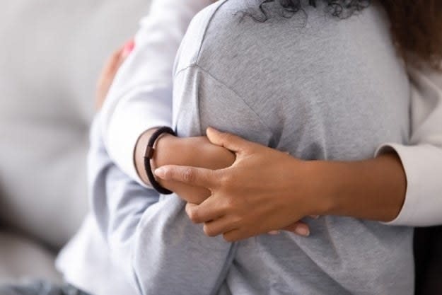 A woman and her daughter daughter embrace