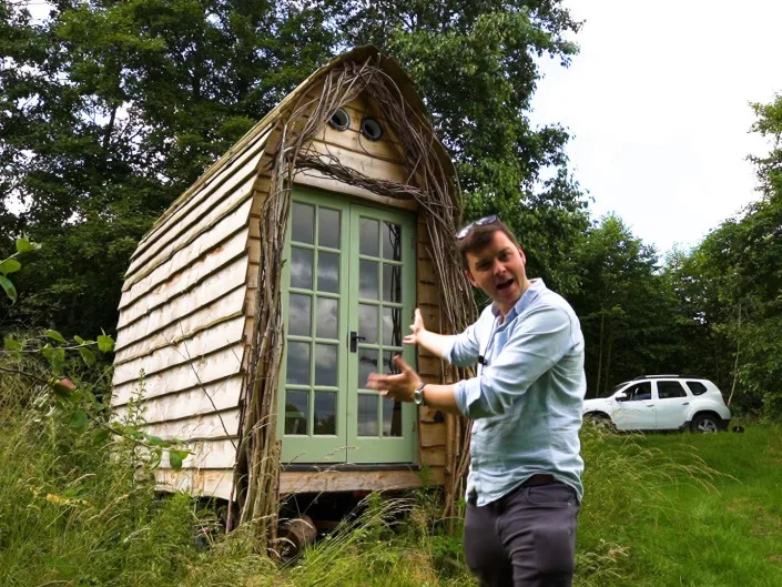 Photo of Jacob Harrell stood outside his tiny home