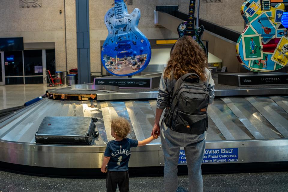 A family waits for their luggage at the Austin-Bergstrom International Airport on May 26, 2023, in Austin, Texas. (Credit: Brandon Bell, Getty Images)