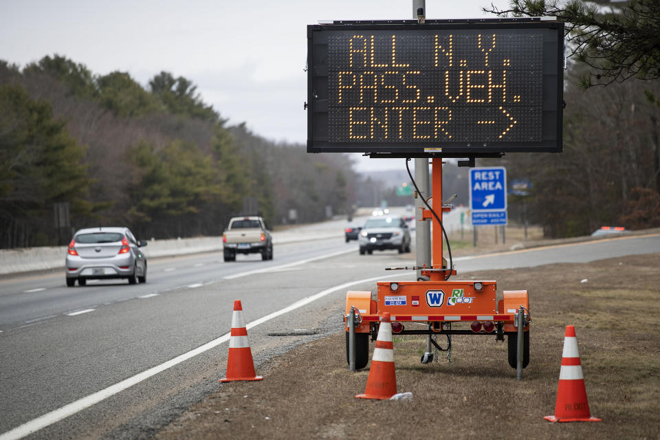 A sign tells motorists with New York license plates to pull over at a checkpoint on I-95 in Rhode Island. (Photo: ASSOCIATED PRESS)