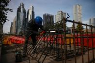 Workers prepares an iron grid for welding at a construction site in the Central Business District (CBD) following an outbreak of the coronavirus disease (COVID-19) in Beijing