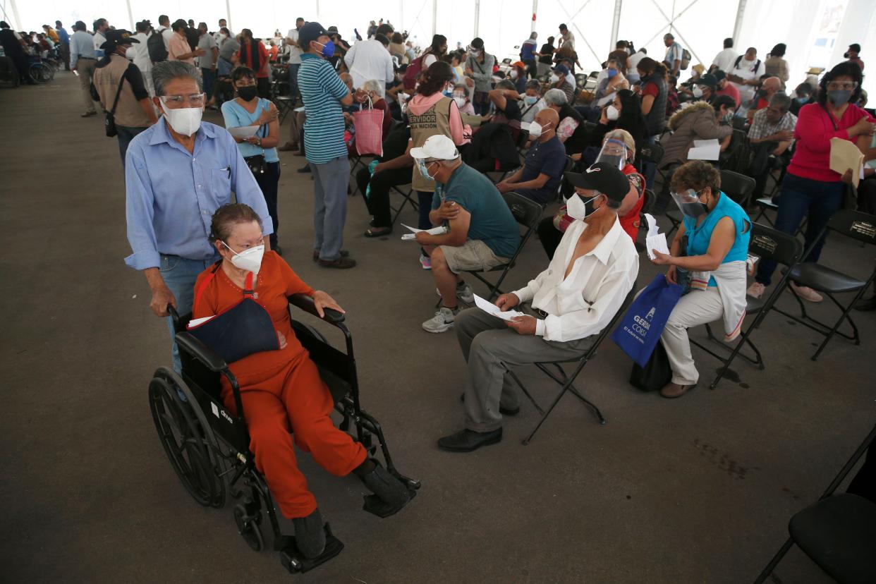 People wait for their Sinovac Biotech COVID-19 vaccine at the Americas sports center in Ecatepec, a borough on the outskirts of Mexico City, on Tuesday, Feb. 23, 2021.