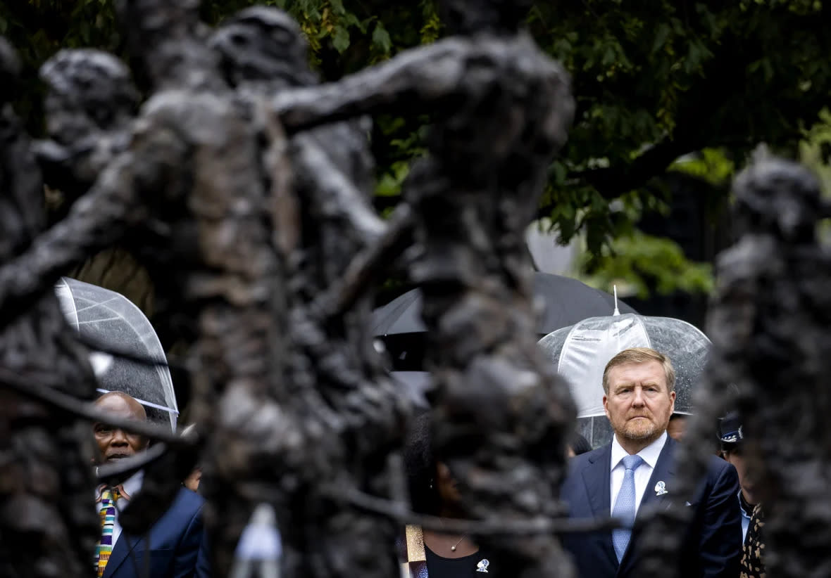 Dutch King Willem-Alexander lays a wreath at the slavery monument after apologizing for the royal house’s role in slavery and asked forgiveness in a speech greeted by cheers and whoops at an event to commemorate the anniversary of the country abolishing slavery in Amsterdam, Netherlands, Saturday, July 1, 2023. (Remko de Waal/Pool Photo via AP)