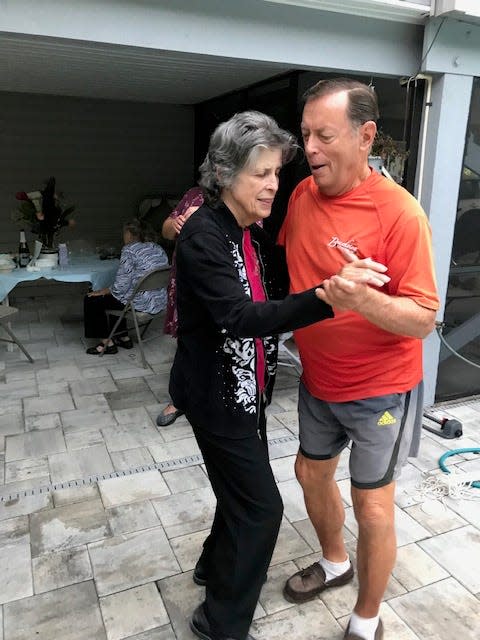 Judi and Joe McEntyre dance at their 60th wedding anniversary party in 2020, outside their home on Sanibel Island. Judi died at home Sept. 8, three weeks before Hurricane Ian forced her family to evacuate.