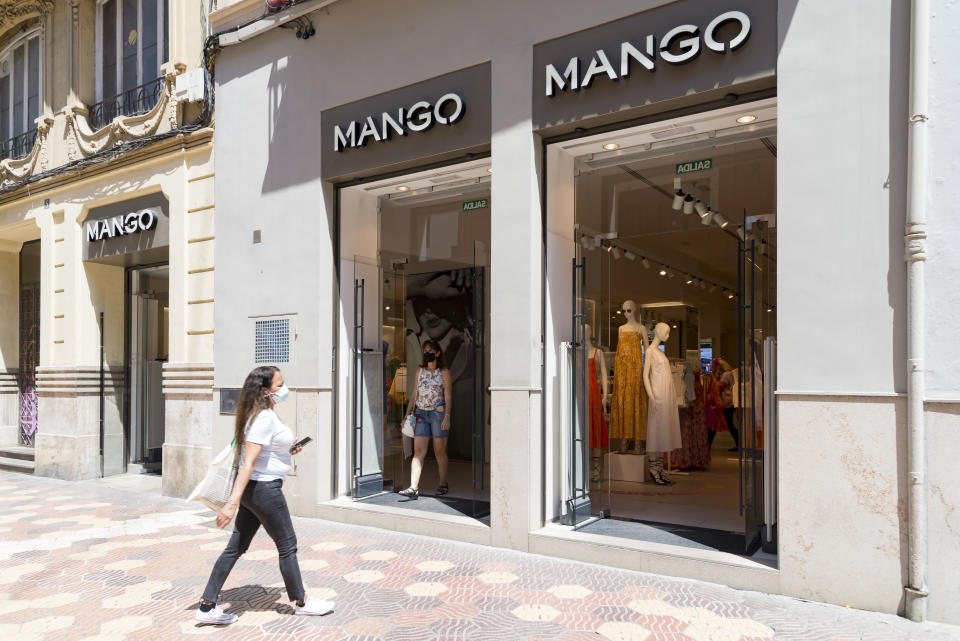 VALENCIA, SPAIN - 2021/06/10: A woman wearing facemask as a precaution against the spread of covid-19 walks into the Mango clothing store. (Photo by Xisco Navarro Pardo/SOPA Images/LightRocket via Getty Images)