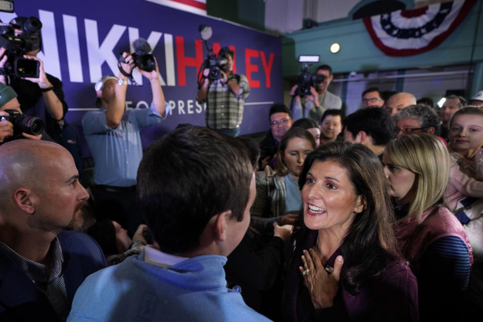 FILE - Republican presidential candidate Nikki Haley, right, greets voters at a town hall campaign event, Thursday, Feb. 16, 2023, in Exeter, N.H. (AP Photo/Robert F. Bukaty, File)