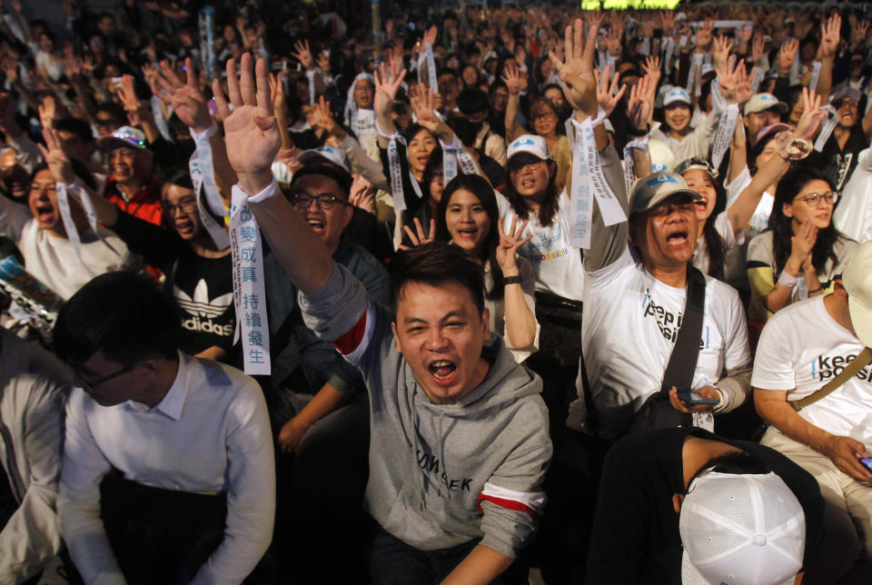 Supporters of Taipei city mayor and city mayoral candidate Ko Wen-je cheer in Taipei, Taiwan, Saturday, Nov. 24, 2018. Taiwan's ruling party suffered a major defeat Saturday in local elections seen as a referendum on the administration of the island's independence-leaning president amid growing economic and political pressure from China. (AP Photo/Chiang Ying-ying)