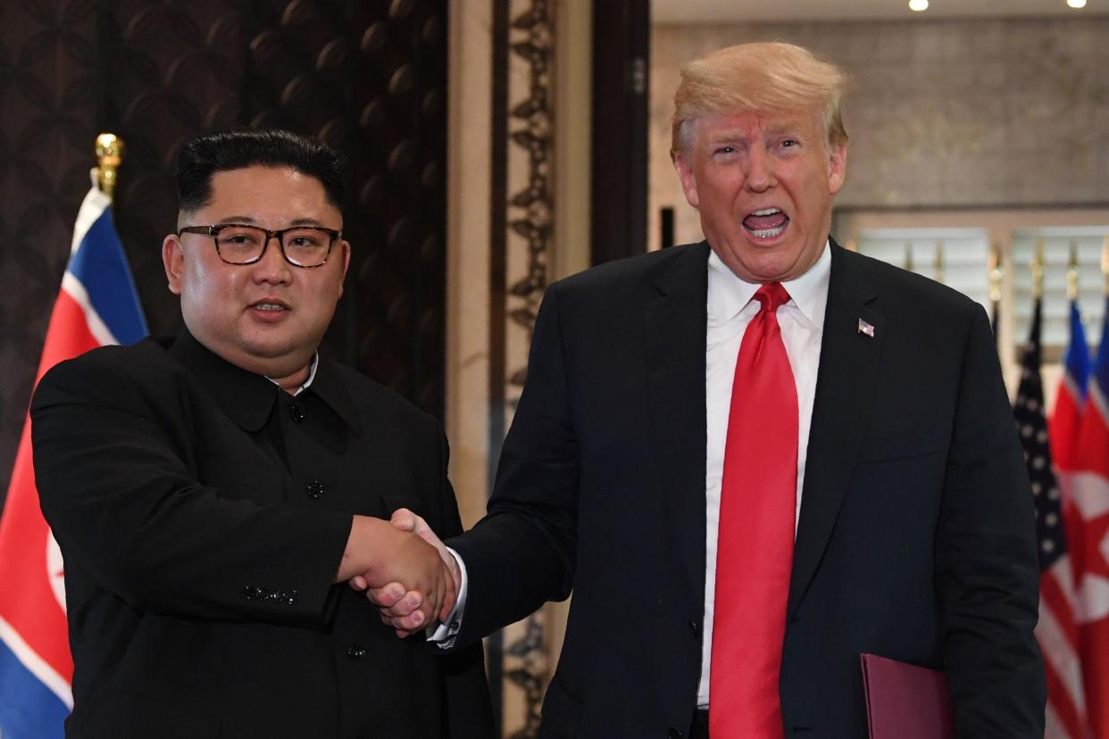 Donald Trump and Kim Jong Un shake hands following a signing ceremony during their historic US-North Korea summit in 2018: AFP/Getty Images