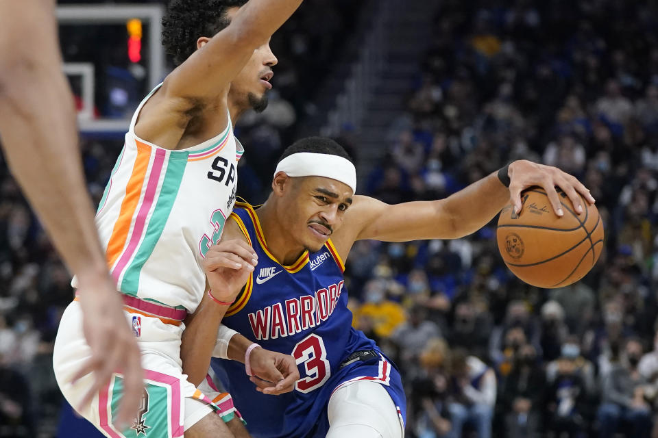 Golden State Warriors guard Jordan Poole, right, is defended by <a class="link " href="https://sports.yahoo.com/nba/teams/san-antonio/" data-i13n="sec:content-canvas;subsec:anchor_text;elm:context_link" data-ylk="slk:San Antonio Spurs;sec:content-canvas;subsec:anchor_text;elm:context_link;itc:0">San Antonio Spurs</a> guard <a class="link " href="https://sports.yahoo.com/nba/players/6433" data-i13n="sec:content-canvas;subsec:anchor_text;elm:context_link" data-ylk="slk:Tre Jones;sec:content-canvas;subsec:anchor_text;elm:context_link;itc:0">Tre Jones</a> during the second half of an NBA basketball game in San Francisco, Saturday, Dec. 4, 2021. (AP Photo/Jeff Chiu)