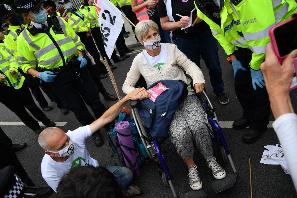 Activists from the climate protest group Extinction Rebellion sit blocking the road, one activist using a wheelchair, outside the Houses of Parliament in central London on September 1, 2020 as the climate ground started their new season of "mass rebellions". - Climate protest group Extinction Rebellion will target Britain's parliament as part of "mass rebellions" starting from September 1. Other actions will take place around the country. (Photo by JUSTIN TALLIS / AFP) (Photo by JUSTIN TALLIS/AFP via Getty Images)