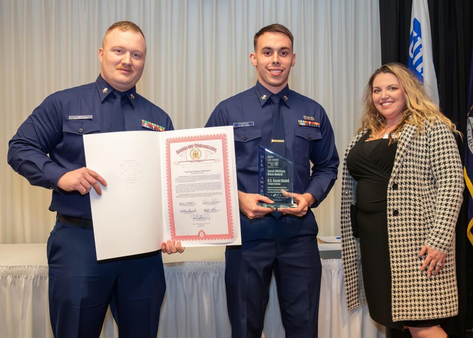 Accepting the Local Military Hero award on behalf of  the U.S. Coast Guard and Toledo Station is Aaron Ross, left, and Adam Figueroa with Ashleigh Glass.