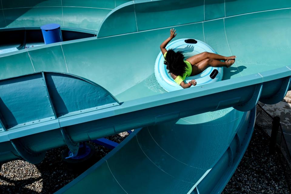 A young patron goes down one of the waterslides on Tuesday, June 20, 2023, at the East Lansing Family Aquatics Center. 