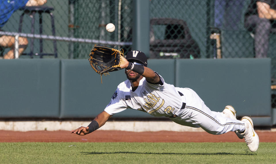 Vanderbilt's Javier Vaz (2) dives to catch a ball hit by Stanford's Eddie Park to close out the second inning during a baseball game in the College World Series Wednesday, June 23, 2021, at TD Ameritrade Park in Omaha, Neb. (AP Photo/Rebecca S. Gratz)