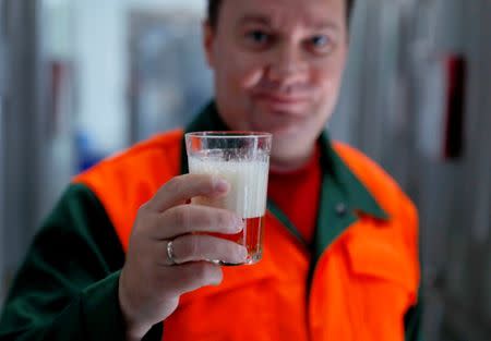 Chief brewer Alexei Saburov poses with a sample of beer at the Melody Brew brewery in Polevskoy, Russia June 19, 2018. Picture taken June 19, 2018. REUTERS/Andrew Couldridge