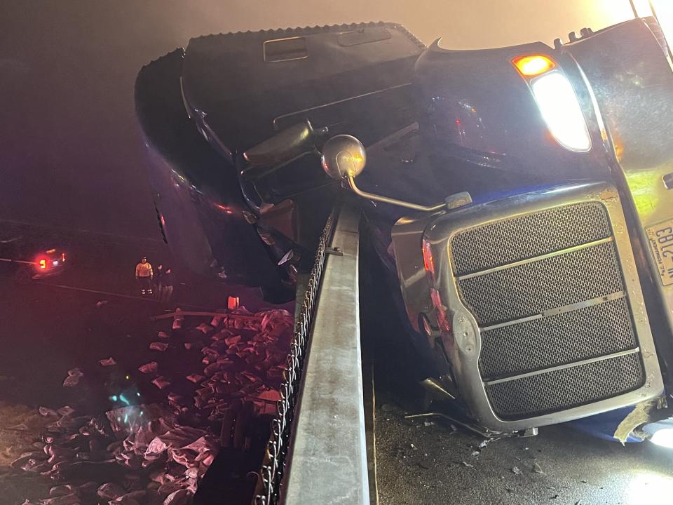 (Courtesy: Avoca Fire Department) The tractor-trailer spilled the mulch it was carrying onto the roadway below the overpass.