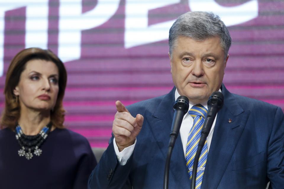 Ukrainian President Petro Poroshenko gestures while speaking as with his wife Maryna looks at him at his headquarters after the second round of presidential elections in Kiev, Ukraine, Sunday, April 21, 2019. Ukrainian President Petro Poroshenko is accepting defeat in the election for the country's top post. (AP Photo/Efrem Lukatsky)