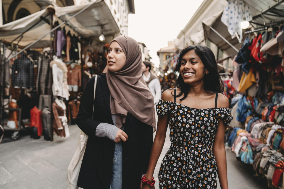 Two friends are walking in San Lorenzo market in Florence, Italy (Getty Images)