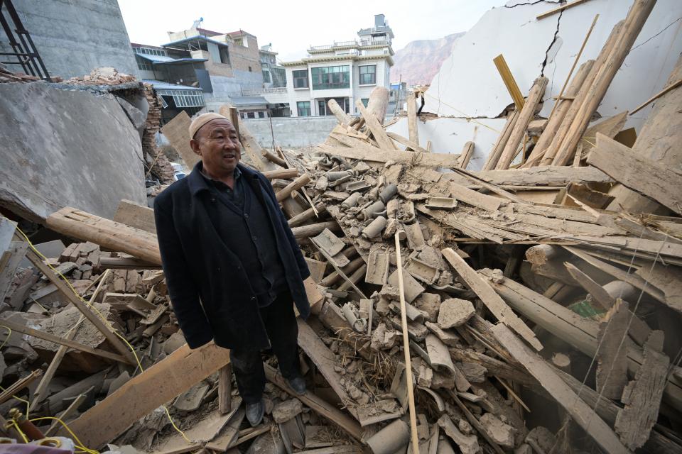 A man inspects a damaged building after an earthquake at Dahejia in Jishishan County in northwest China's Gansu province on December 20, 2023.