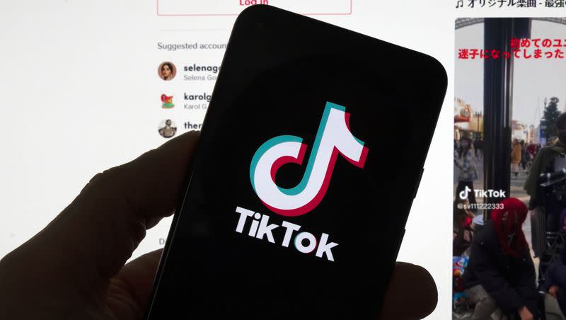 The TikTok logo is seen on a mobile phone in front of a computer screen displaying the TikTok home home screen on March 18, 2023, in Boston. Social media platforms often rely on labels to let users know an account is operated by a Russian state propaganda agency. But new research shows that on TikTok at least, the labels aren’t very effective even when they’re applied consistently.