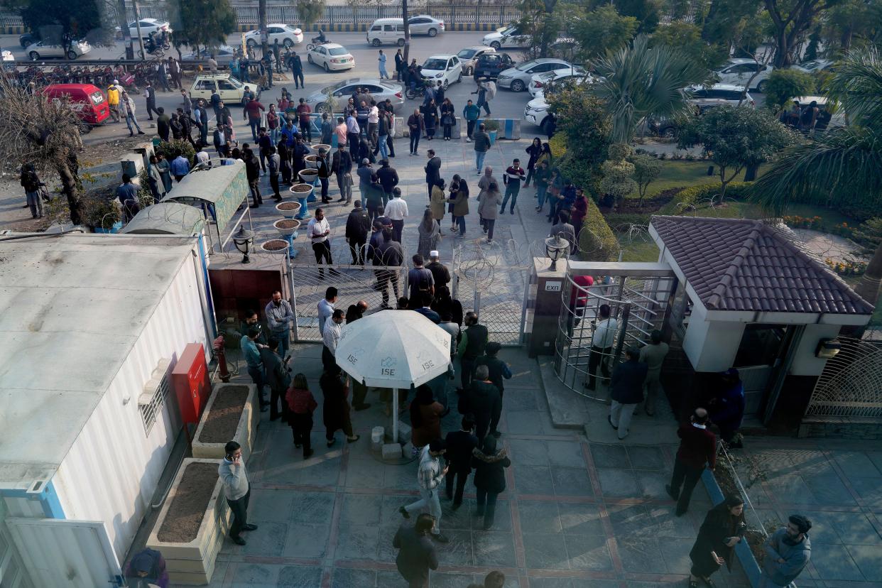 People leave their offices building after an earthquake was felt in Islamabad, Pakistan, Thursday, Jan. 11, 2024.