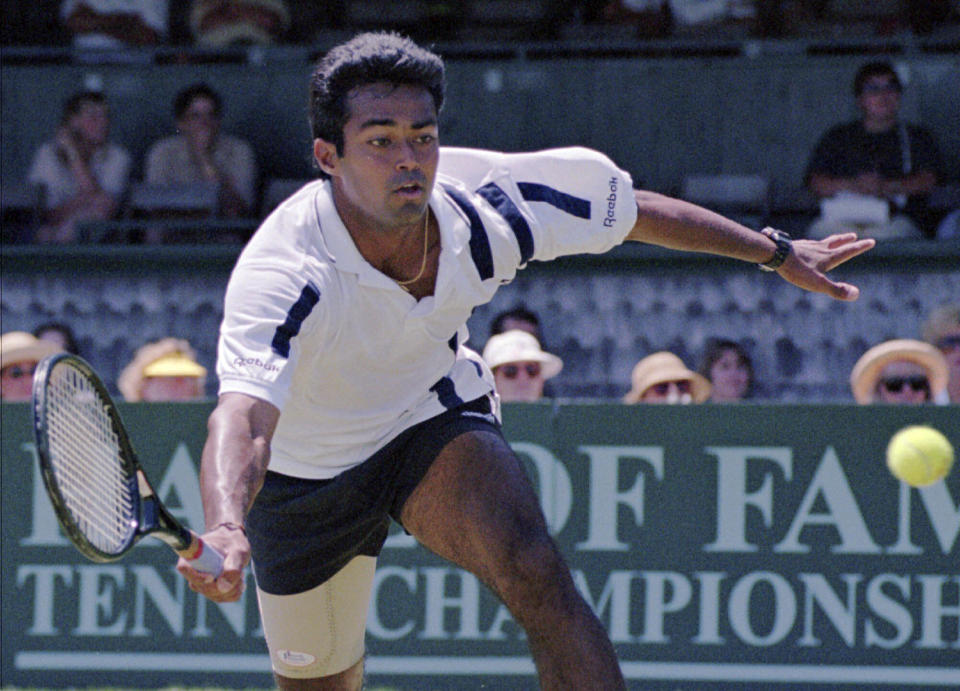 FILE - Leander Paes, of India, tries to maintain his balance while charging the ball during the quarterfinals of the Hall of Fame Tennis Championships in Newport, R.I., Thursday, July 10, 1997. Paes, who won 18 Grand Slam titles in men’s doubles or mixed doubles, and Vijay Amritraj are the first Asian men elected to the International Tennis Hall of Fame. The Hall announced its Class of 2024 on Wednesday., Dec. 13, 2023. (AP Photo/Matt York, File)